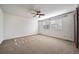 Spacious carpeted bedroom featuring a ceiling fan and light-filled windows at 14035 Touchstone St, Parker, CO 80134