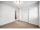 Bright bedroom with neutral carpet and a door leading to a closet or en-suite at 14035 Touchstone St, Parker, CO 80134