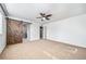 Large bedroom with wood sliding barn door feature and walk-in closet at 14035 Touchstone St, Parker, CO 80134