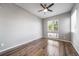 This bedroom features hardwood floors, a ceiling fan and plenty of natural light from a large window at 14035 Touchstone St, Parker, CO 80134