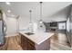 Open kitchen with stainless steel appliances and white countertops with view to living room with fireplace at 14035 Touchstone St, Parker, CO 80134