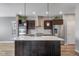 Modern kitchen featuring stainless steel appliances, dark cabinets, and a large center island with a white countertop at 14035 Touchstone St, Parker, CO 80134