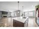 Open kitchen with stainless steel appliances and white countertops with view to living room with fireplace at 14035 Touchstone St, Parker, CO 80134
