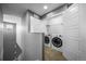 Efficient laundry room tucked off the hallway, equipped with modern front-load washer and dryer at 14035 Touchstone St, Parker, CO 80134
