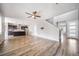 Spacious living room featuring wood floors, a ceiling fan, and an open layout to the kitchen at 14035 Touchstone St, Parker, CO 80134