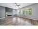 The spacious living room features hardwood floors, a fireplace and large windows that provide plenty of natural light at 14035 Touchstone St, Parker, CO 80134