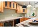 Home bar featuring wood cabinets, stone counters, beverage cooler, and sink at 29962 Troutdale Ridge Rd, Evergreen, CO 80439