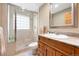 Bathroom featuring a stone shower and wood vanity with white sink at 29962 Troutdale Ridge Rd, Evergreen, CO 80439