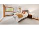 Bright, well-lit bedroom with neutral decor, a cozy chair, and large windows to enjoy outdoor views at 29962 Troutdale Ridge Rd, Evergreen, CO 80439