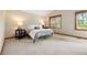 Bright bedroom with neutral tones, large windows, plush carpet, and space for comfortable furnishings at 29962 Troutdale Ridge Rd, Evergreen, CO 80439