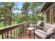 Charming deck with comfortable seating area, overlooking lush greenery and mature trees at 29962 Troutdale Ridge Rd, Evergreen, CO 80439