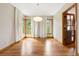Dining room with hardwood floors, neutral walls, natural light, and contemporary light fixture at 29962 Troutdale Ridge Rd, Evergreen, CO 80439