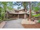 Charming two-story home with a private drive, mature landscaping, and an attached two car garage at 29962 Troutdale Ridge Rd, Evergreen, CO 80439