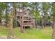 Multi-level house featuring spacious decks, set amidst a lush, wooded landscape providing privacy and natural beauty at 29962 Troutdale Ridge Rd, Evergreen, CO 80439