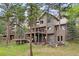 Beautiful multi-level home with multiple decks, nestled among mature trees and landscaping at 29962 Troutdale Ridge Rd, Evergreen, CO 80439