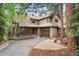 Inviting two-story home featuring a well-maintained lawn, mature trees, and an attached two-car garage at 29962 Troutdale Ridge Rd, Evergreen, CO 80439