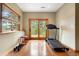 Home gym with treadmill, weights, wood floors and a sliding glass door at 29962 Troutdale Ridge Rd, Evergreen, CO 80439