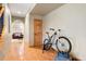 Hallway with hardwood floors and view into a living room at 29962 Troutdale Ridge Rd, Evergreen, CO 80439