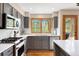 Modern kitchen featuring stainless steel appliances, an island, and scenic outdoor views at 29962 Troutdale Ridge Rd, Evergreen, CO 80439