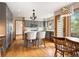 Spacious kitchen features an island, hardwood floors, gray cabinets, and access to a deck at 29962 Troutdale Ridge Rd, Evergreen, CO 80439
