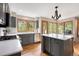 Modern kitchen with stainless steel appliances, a central island, and scenic outdoor views at 29962 Troutdale Ridge Rd, Evergreen, CO 80439