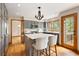 Spacious kitchen features an island, hardwood floors, gray cabinets, and access to a deck at 29962 Troutdale Ridge Rd, Evergreen, CO 80439