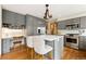 Well-appointed kitchen with stainless steel appliances, island with seating, and built-in desk area at 29962 Troutdale Ridge Rd, Evergreen, CO 80439