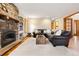 Living room featuring a stone fireplace, hardwood floors, and plush leather seating at 29962 Troutdale Ridge Rd, Evergreen, CO 80439
