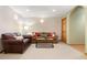 Cozy living room with sofas and view into hallway at 29962 Troutdale Ridge Rd, Evergreen, CO 80439