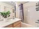 Well-lit bathroom features a tub, shower, large mirror, and a plant adding a natural touch at 1601 Great Western Dr # D3, Longmont, CO 80501