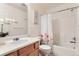 Bright bathroom featuring a vanity, toilet, shower and tub combo with a floral shower curtain at 1601 Great Western Dr # D3, Longmont, CO 80501