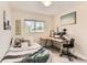 Cozy bedroom features a comfortable bed and a functional desk area with natural light from the window at 1601 Great Western Dr # D3, Longmont, CO 80501