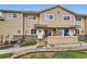 Charming exterior view of a tan townhome with a lovely front porch and well-maintained landscaping at 1601 Great Western Dr # D3, Longmont, CO 80501