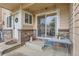 Charming front porch featuring a cozy seating area and access to the home's entrance at 1601 Great Western Dr # D3, Longmont, CO 80501