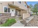 Inviting front porch with table and chairs, leading to a well-maintained townhome exterior at 1601 Great Western Dr # D3, Longmont, CO 80501