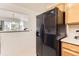 The kitchen features a black refrigerator and pass-through to the living room at 1601 Great Western Dr # D3, Longmont, CO 80501