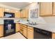Functional kitchen with black appliances, light cabinets, and ample countertop space at 1601 Great Western Dr # D3, Longmont, CO 80501