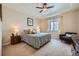 Comfortable bedroom featuring plush carpet, ceiling fan, and a seating area by the window at 3325 Yale Dr, Broomfield, CO 80023