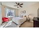 Sunlit bedroom featuring a large window, ceiling fan, and red chair at 3325 Yale Dr, Broomfield, CO 80023