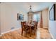 Formal dining room featuring hardwood floors, elegant chandelier, and seating for six people at 3325 Yale Dr, Broomfield, CO 80023