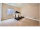 A personal gym space with a treadmill and natural light at 3325 Yale Dr, Broomfield, CO 80023