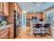 Modern kitchen featuring stainless steel appliances, a center island with bar stools, and wooden cabinets at 3325 Yale Dr, Broomfield, CO 80023