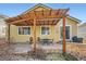 Relaxing backyard patio with a pergola, outdoor seating, and a well-maintained brick surround at 3325 Yale Dr, Broomfield, CO 80023