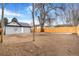 Spacious backyard with wooden fence and mature trees at 655 S Osceola St, Denver, CO 80219