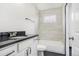 Clean bathroom with white vanity, tub, and dark countertop at 655 S Osceola St, Denver, CO 80219