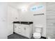 Modern bathroom with a double vanity and dark countertop at 655 S Osceola St, Denver, CO 80219