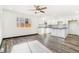 Modern kitchen with white cabinets, island, and gray flooring at 655 S Osceola St, Denver, CO 80219