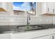 Modern kitchen sink with black countertop and white cabinets at 655 S Osceola St, Denver, CO 80219