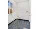 Simple laundry room with gray tile floor and window at 655 S Osceola St, Denver, CO 80219