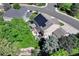 Aerial view of home with solar panels, deck, green yard, and lush landscaping at 10142 Mountain Maple Dr, Highlands Ranch, CO 80129
